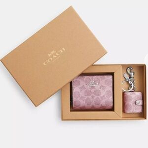 Boxed Snap Wallet And Picture Frame Charm
In Signature Canvas